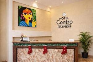 a hotel centre reception desk with red christmas stockings at Hotel Centro in Calangute