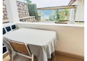 a table and a chair in a room with a window at Kivu Hotel Resort in Kibuye +64 photos