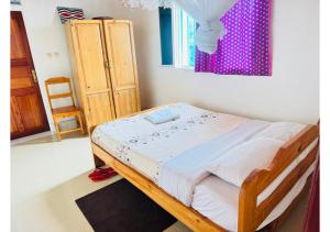 a bed in a room with a window at Kivu Hotel Resort in Kibuye