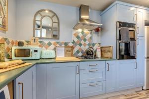 a kitchen with blue cabinets and a counter top at 2 Bed in Bakewell oc-t34225 in Bakewell +11 photos
