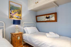 a small bedroom with two beds and a mirror at 2 Bed in Bakewell oc-t34225 in Bakewell