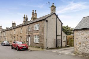 a red car parked in front of a brick building at 2 Bed in Bakewell oc-t34225 in Bakewell