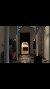a room with a fireplace with a bed in it at Riad mama aicha in Asilah