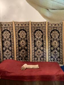 a statue of a dog laying on a bed at Riad mama aicha in Asilah