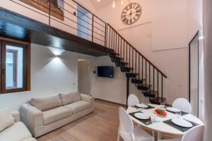 a living room with a table and a couch at My exclusive cavour loft da sogno a cagliari in Cagliari