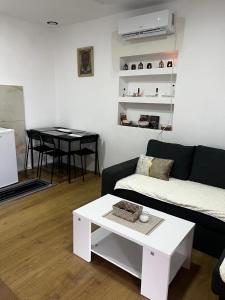 a living room with a couch and a table at Skadar Lake Stone House in Podgorica