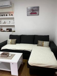 a living room with a couch and a table at Skadar Lake Stone House in Podgorica