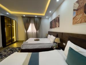 a hotel room with two beds and a window at Pyramids Sunshine Hotel in Cairo