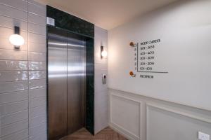 a elevator in a bathroom with a metal door at Maestro St Lazar Apartments in Larnaca +50 photos