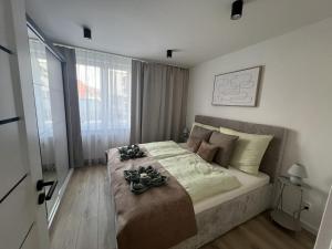 a bedroom with a large bed with flowers on it at Apartmán LÝRA Trenčín in Trenčín +1 photo