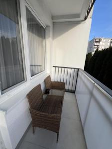 a balcony with two chairs and a table at Apartmán LÝRA Trenčín in Trenčín