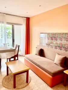 a living room with a couch and a table at Résidence Bertille Abidjan Cocody in Abidjan +32 photos