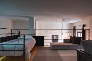 a bedroom with a bed and a couch at My exclusive cavour loft da sogno a cagliari in Cagliari +168 photos