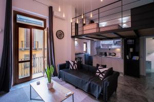a living room with a couch and a table at My exclusive cavour loft da sogno a cagliari in Cagliari