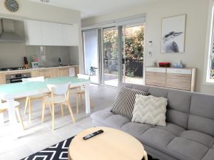 a living room with a couch and a table at Cosy Private Modern Flat in Epping