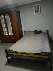 a bed sitting in a bedroom with a mirror at Дідова Хата in Sheshory