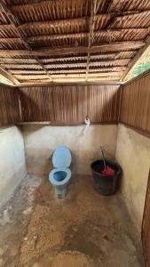 a bathroom with a blue toilet and a bucket at Saubaryam Home stay in Fam