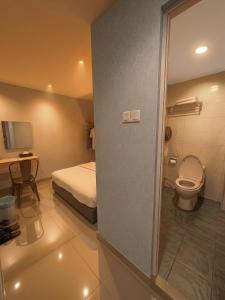a small bathroom with a bed and a toilet at De UPTOWN Hotel @ P.J. 222 in Petaling Jaya +27 photos