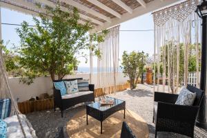 a patio with chairs and a table on a balcony at Little Garden in Pera Gyalos
