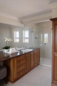 a bathroom with a sink and a shower at The Gables Boutique Hotel in Chintsa +45 photos