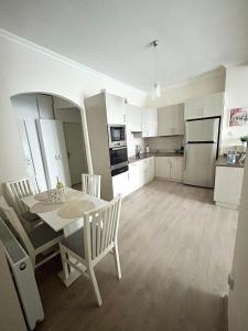 a kitchen and dining room with a table and chairs at BartokLux in Budapest