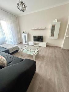 a living room with a couch and a glass table at BartokLux in Budapest