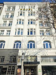 a white building with a store in front of it at Garner Hotel Hamburg St. Georg by IHG in Hamburg