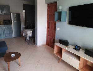 a living room with a flat screen tv on a wall at Cá Morten in Santa Maria