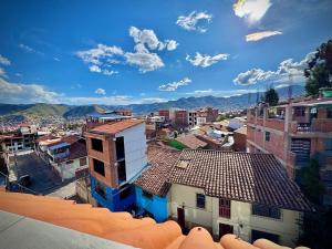 an overhead view of a city with buildings and mountains at Apu Wasi in Cusco