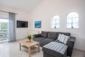 a living room with a couch and a table at Apartment Margerita in Asgourou