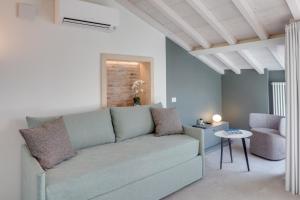 a living room with a couch and a table at Zeno Suites in Verona +49 photos