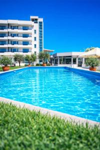 a large swimming pool in front of a building at Sahat Kula Residence Hotel in Ulcinj