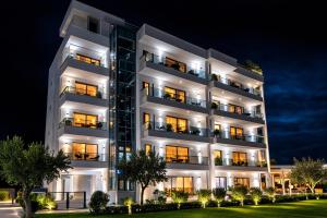 a nighttime photo of a building with lights at Sahat Kula Residence Hotel in Ulcinj