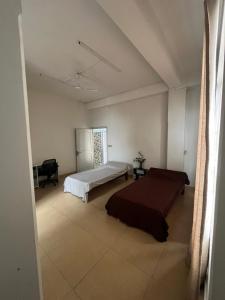 a bedroom with a bed and a desk in it at W-26 Dawrpui in Āīzawl