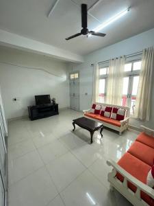 a living room with a red couch and a table at W-26 Dawrpui in Āīzawl