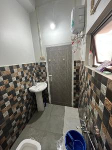 a bathroom with a toilet and a sink at W-26 Dawrpui in Āīzawl