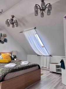 a bedroom with a bed and a window with butterflies on the ceiling at Atpūta Mālpilī in Mālpils