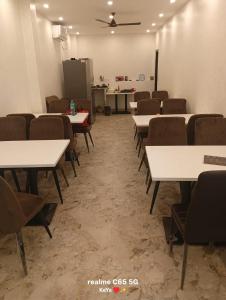 an empty room with tables and chairs in a classroom at Creek Row in Kolkata