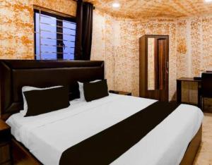a bedroom with a large bed and a window at Creek Row in Kolkata