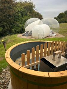 a wooden barrel with two domes in a park at Wooded Bubble in Kent