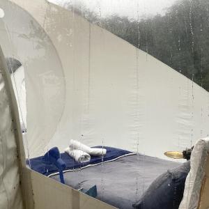 a glass wall with a snowboard in a room at Wooded Bubble in Kent