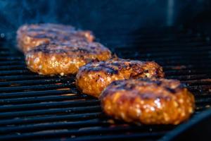 a group of hamburgers cooking on a grill at Wooded Bubble in Kent