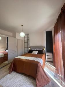 a bedroom with a large bed and a large window at Villa Thalia in Alexandroupoli