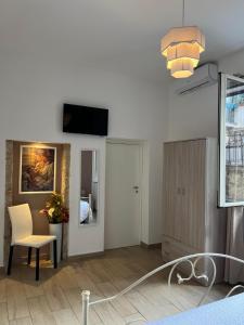 a living room with a table and a chair at Antiche mura in Palermo