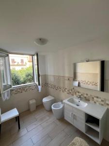 a bathroom with a sink and a toilet and a mirror at Antiche mura in Palermo +27 photos