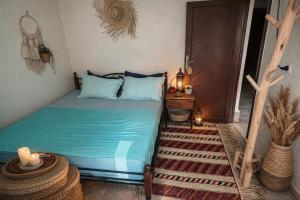 a bedroom with a bed and a table with candles at Studio in City Center Living at Heart of It All, 200 m away from CTM in Er Rachidia