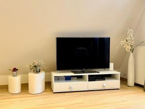 a flat screen tv sitting on a white entertainment center at Ferienwohnung Brigitta in Hambühren