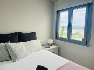 a bedroom with a bed and a window with the ocean at Ático frontal al mar en Duna Beach con vistas in Torrox Costa +56 photos