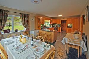 a kitchen and dining room with a table and chairs at 6 Bed in Clonbur oc-i275 in Finny