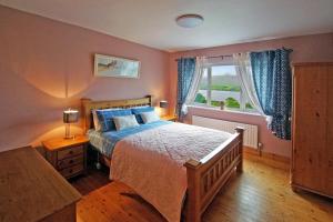 a bedroom with a large bed and a window at 6 Bed in Clonbur oc-i275 in Finny